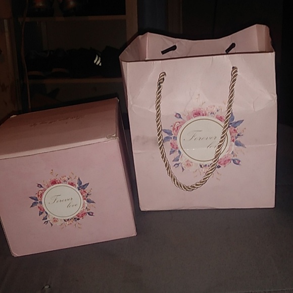 A heart necklace and small heart shaped box